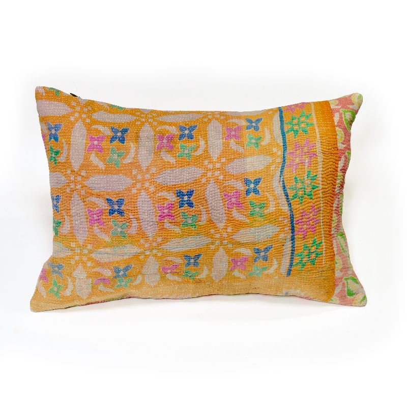 A handcrafted Kantha cushion with an orange fabric cover, featuring intricate multicolored floral embroidery patterns in pink, blue, and green, accented by a colorful border