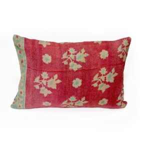 A handcrafted Kantha cushion with a rich red fabric cover, featuring intricate white and green floral embroidery patterns, accented by a subtle green border