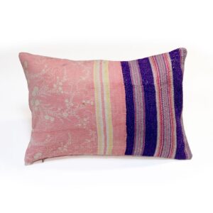 A handcrafted Kantha cushion with a pink fabric cover featuring white floral embroidery on the left, transitioning to a section with vertical purple, pink, and yellow stripes on the right