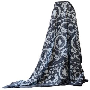 Handmade kantha quilt with a soft grey base, intricate floral motifs, and delicate multicolored embroidery, showcasing traditional stitching on premium cotton and wool fibers for a cozy, bohemian home decor accent.