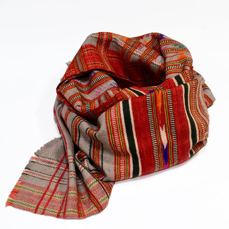 Hand-crafted Khadi Wool Shawl from villages outside Rajasthan, featuring red, grey, and multicolored stripes with plaid and checkered patterns, geometric tribal motifs, and a decorative border, made from sustainable wool and cotton for a warm, bohemian meditation or peace shawl.