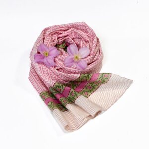 Hand block printed on organic cotton scarf with a warm pink base, intricate green floral patterns, delicate green vine motifs, and a refined geometric border, showcasing traditional techniques and natural dyes for a vibrant, eco-friendly accessory.