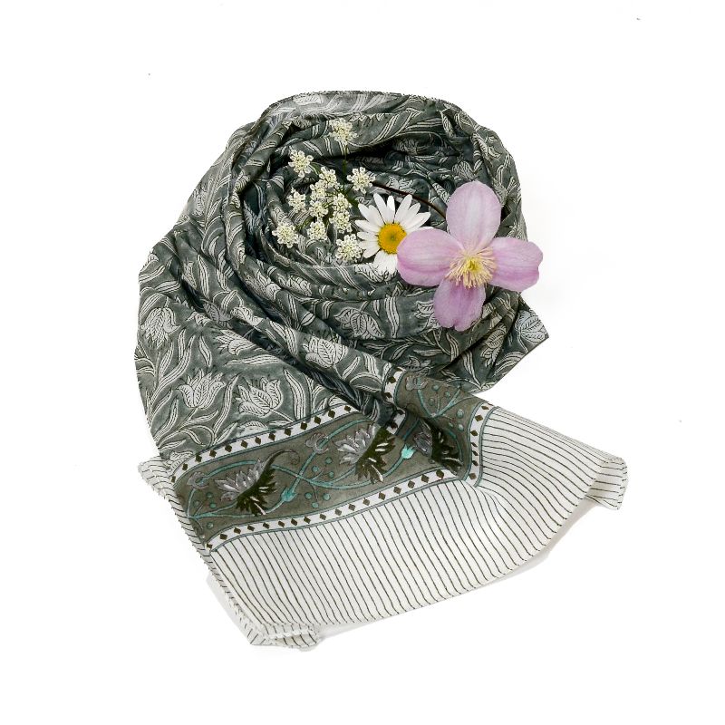 Hand block printed on organic cotton scarf with an olive green base, intricate floral patterns, leaf motifs, vine designs, and a delicate striped border, showcasing traditional hand-stitched embroidery for an elegant, eco-friendly, bohemian accessory.