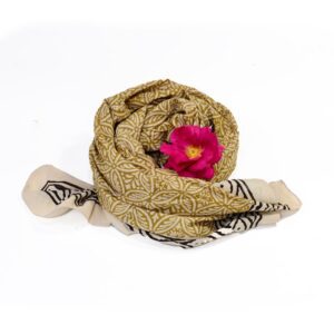Hand block printed on organic cotton Pareo Beach Sarong with a rich yellow base, intricate geometric and floral motifs in beige, cream, gold, black, and white, featuring a bold symmetrical border with dotted accents, showcasing traditional craftsmanship for a stylish, eco-friendly beach accessory.