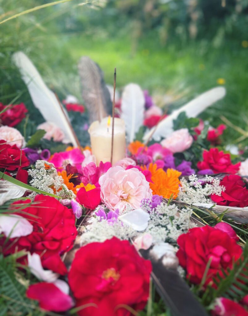 mandala created for grief ceremony from roses and candle