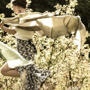 girl running through a meadow in geometric blue wrap skirt