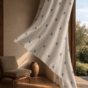 Geometric Arrow block printed linen curtain draped gracefully in a sunlit rustic living room overlooking an olive garden.