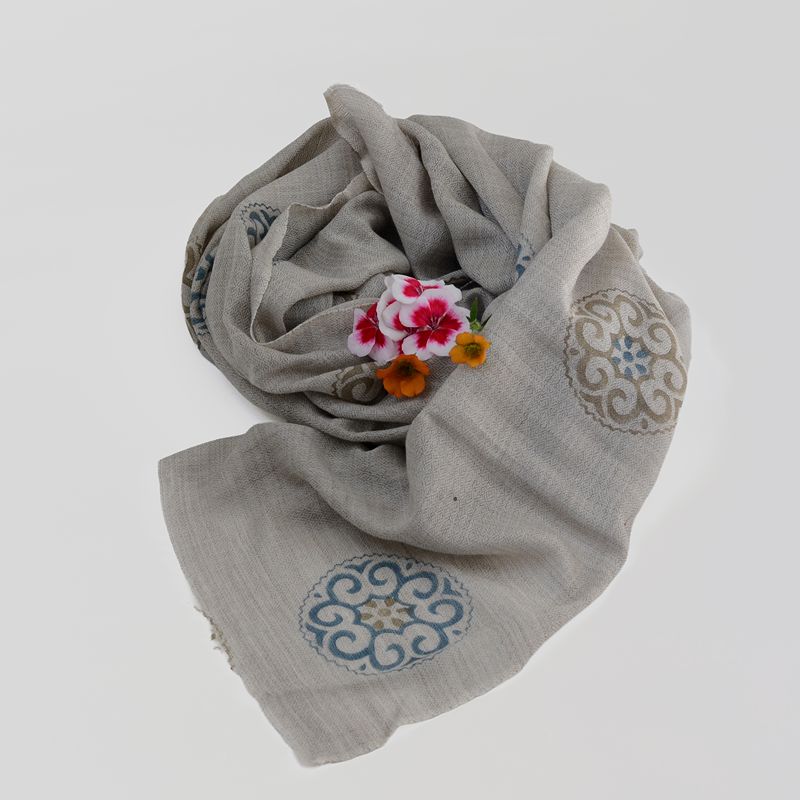 Soft grey pure cashmere scarf featuring hand-block printed blue and gold circular medallion motifs with a flower
