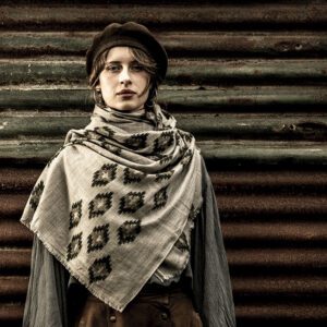 Light grey cashmere wrap with an all-over hand-block printed scalloped arc lattice and gold-bronze floral filling.